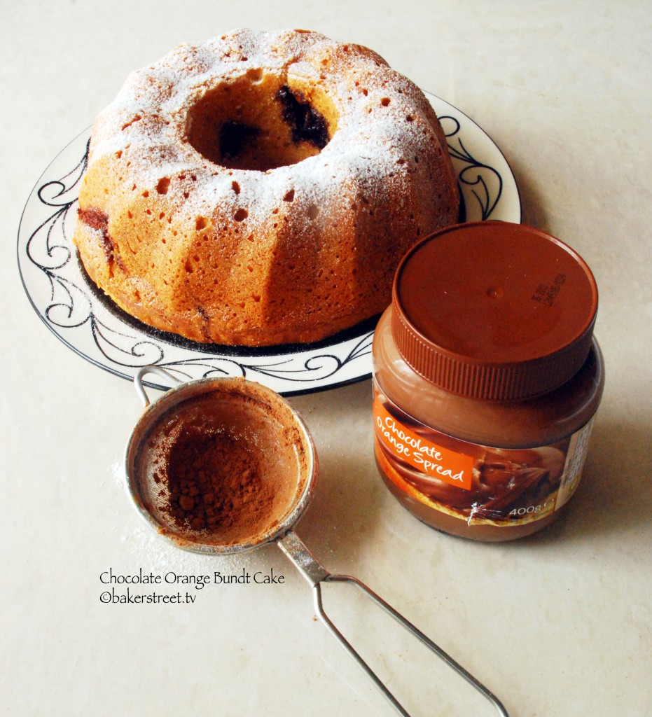 https://bakerstreet.tv/wp-content/uploads/2012/06/Orange-Chocolate-Bundt-Cake2-3-931x1024.jpg